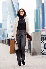 Image showing Beautiful middle-aged business woman with a small suitcase in ha