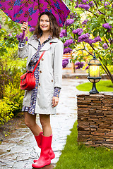 Image showing woman dressed up in a raincoat with an umbrella