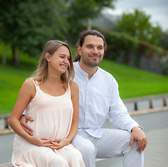 Image showing A young man and a pregnant woman in bright clothes