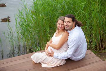 Image showing Happy couple resting by the lake