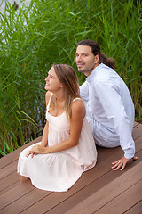 Image showing Pregnancy. Happy couple resting by the lake. 