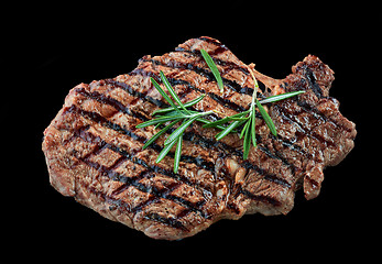 Image showing grilled beef steak meat on black background