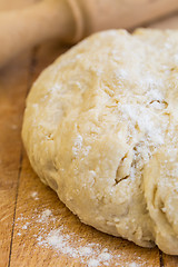 Image showing Fresh raw yeast dough with rolling pin