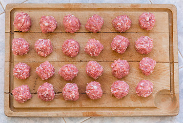 Image showing Raw meatballs on the cutting board 