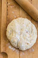 Image showing Fresh raw yeast dough with rolling pin