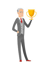 Image showing Senior caucasian businessman holding a trophy.