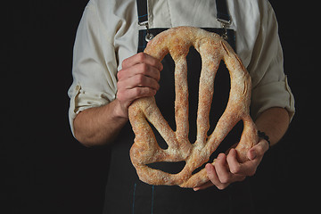 Image showing Baker\'s hands hold fougas bread