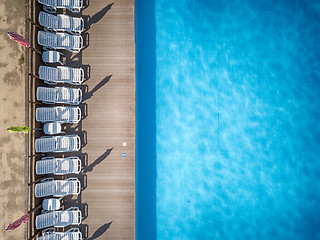 Image showing Beach chairs near swimming pool, top view