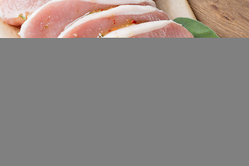 Image showing raw pork escalope with sause made of honey and herbs