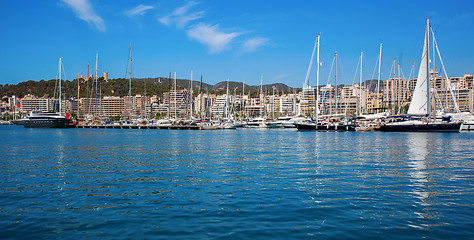 Image showing boats in clear blue water of bright summer day.