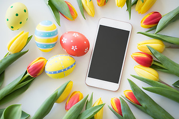 Image showing smartphone with easter eggs and tulip flowers