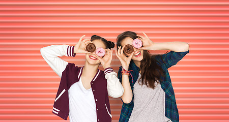 Image showing happy teenage girls or friends with donuts on eyes