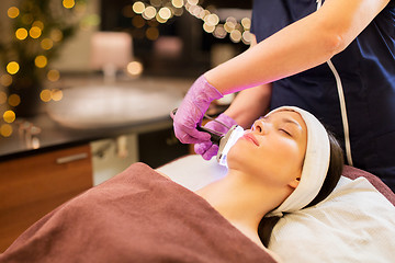 Image showing young woman having face microdermabrasion at spa