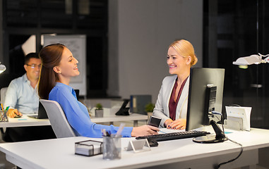 Image showing businesswomen with smartphone late at night office