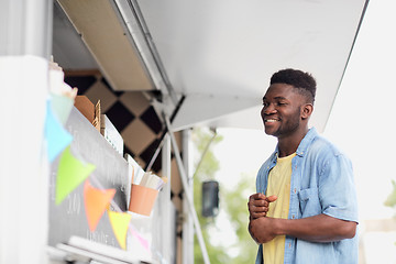 Image showing male customer looking at billboard at food truck