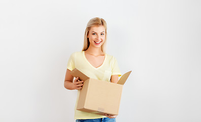 Image showing happy woman holding cardboard box