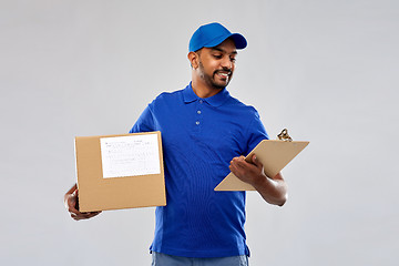 Image showing indian delivery man with parcel box and clipboard
