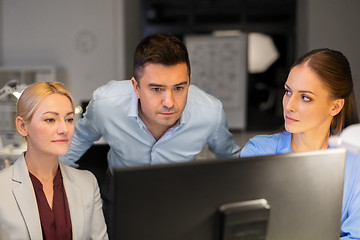 Image showing business team with computer working late at office