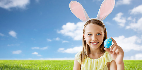 Image showing happy girl with colored easter egg