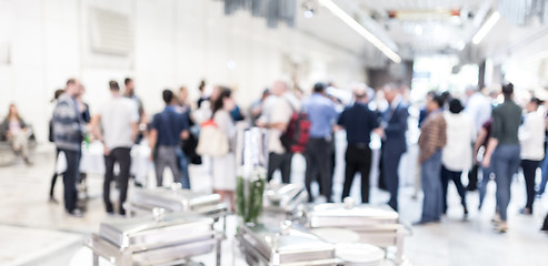 Image showing Blured image of businesspeople at coffee break at conference meeting.