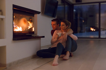 Image showing happy couple in front of fireplace