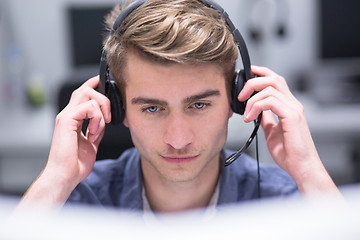 Image showing male call centre operator doing his job