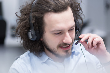 Image showing male call centre operator doing his job