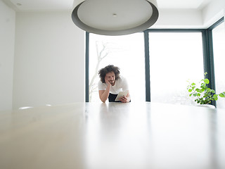 Image showing young man using a tablet at home