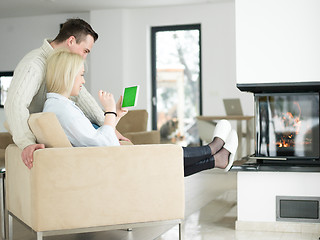 Image showing Couple using digital tablet on cold winter day