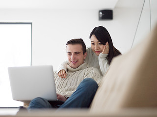 Image showing multiethnic couple using laptop computers