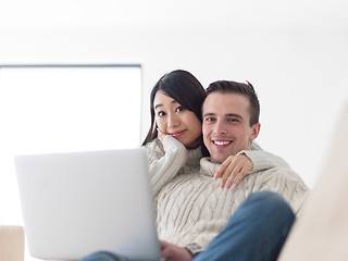 Image showing multiethnic couple using laptop computers