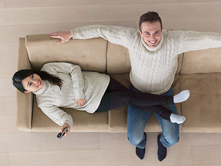 Image showing multiethnic couple on the sofa watching television