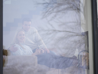 Image showing Couple using digital tablet on cold winter day