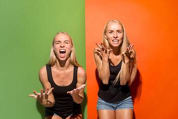 Image showing The young emotional angry women screaming on studio background