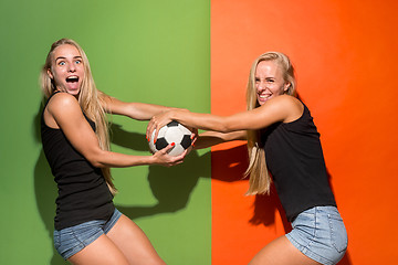 Image showing Fan sport woman player holding soccer ball