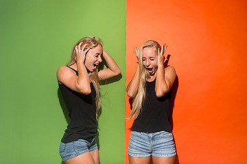 Image showing The young emotional angry women screaming on studio background