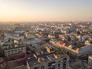 Image showing The panoramic bird\'s eye view from drone to the central historical part of the city Kiev - the Podol district, the Dnieper River in Kiev, Ukraine at summer sunset.