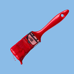 Image showing red paintbrush isolated on a blue background