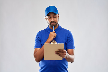 Image showing indian delivery man with clipboard in blue