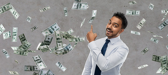 Image showing indian businessman pointing finger at money