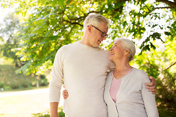 Image showing happy senior couple hugging at summer park