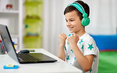 Image showing boy celebrating victory in computer video game