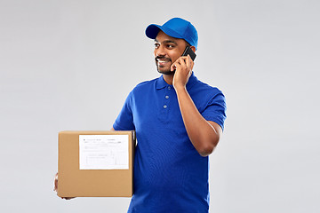 Image showing indian delivery man with smartphone and parcel box