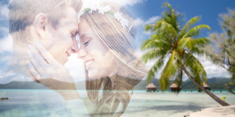 Image showing hippie couple fading over exotic beach background