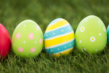 Image showing row of colored easter eggs on artificial grass