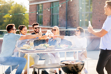 Image showing friends toast drinks at bbq party on rooftop