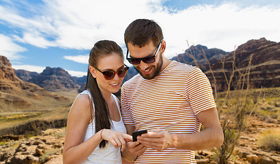 Image showing couple with smartphone in summer over grand canyon