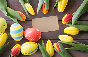 Image showing close up of colored easter eggs and tulip flowers