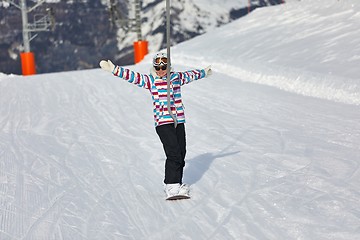 Image showing Female snowboarder using ski lift