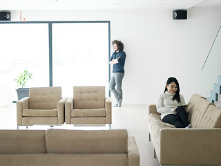 Image showing multiethnic couple at home using tablet computers